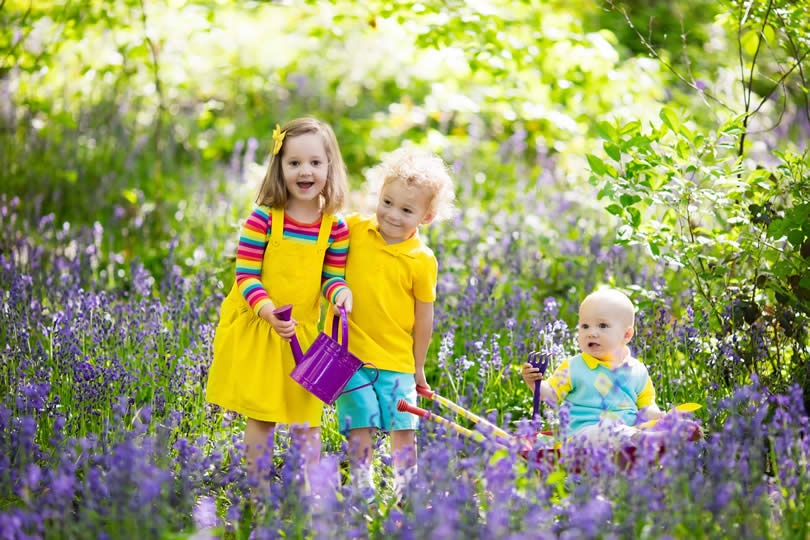 Kids in a park with flowers