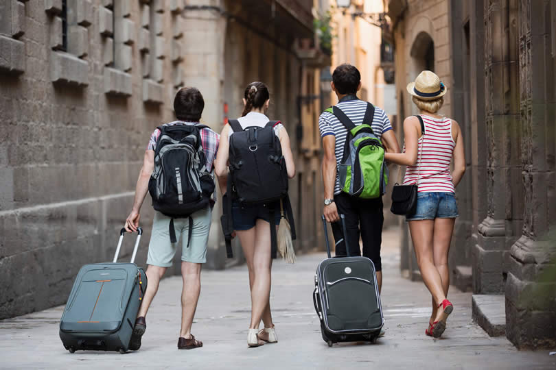 Tourists arriving in city with suitcases
